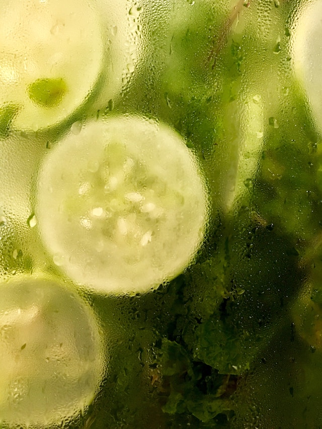 Close-up of pickled sliced cucumbers in a jar